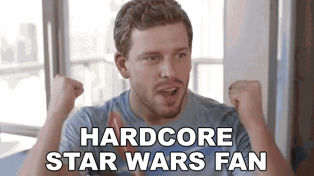 a man with his fist in the air and the words hardcore star wars fan
