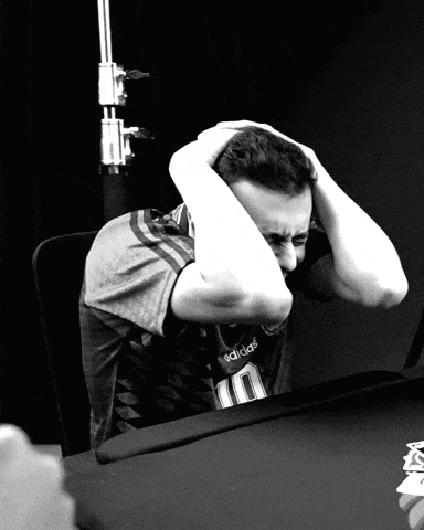 a man wearing an adidas shirt is sitting at a table