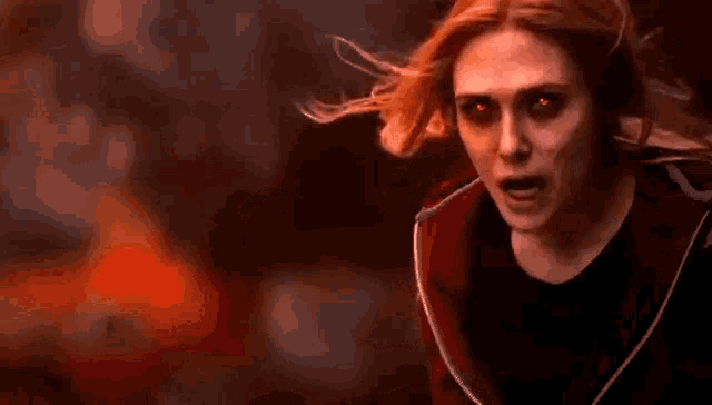 scarlet witch is a superhero with red eyes and long red hair .