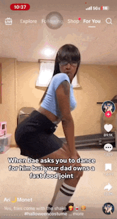 a woman in a blue top and black skirt is dancing on a tik tok video