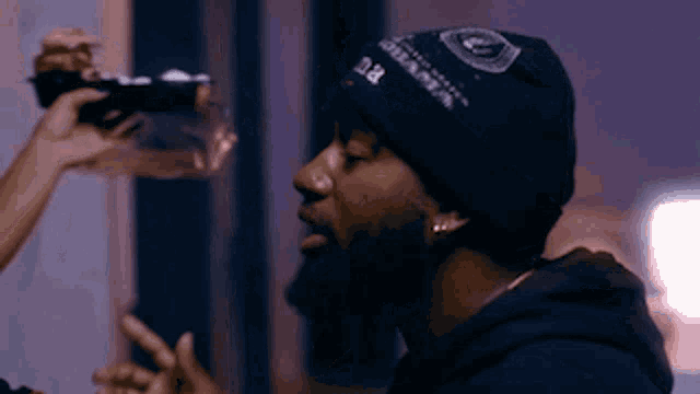 a man wearing a black beanie that says r.i.p.