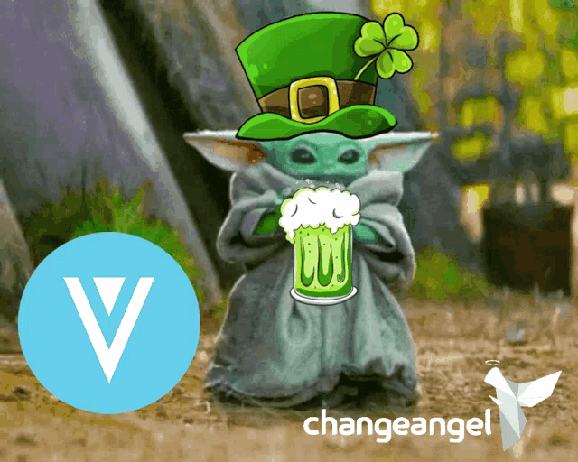 a baby yoda wearing a green hat is holding a green beer mug