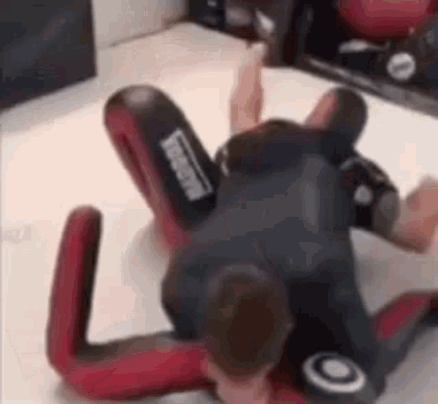 a man is wrestling another man in a wrestling ring .