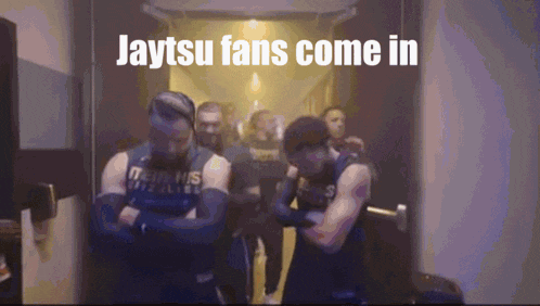 a group of men standing in a hallway with the words jaytsu fans come in