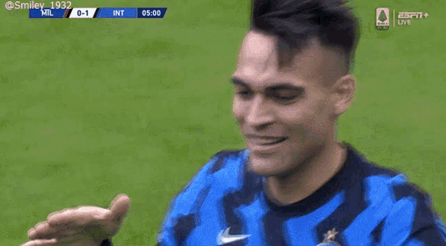 two soccer players are hugging each other on a field and one has the name harimi on his back