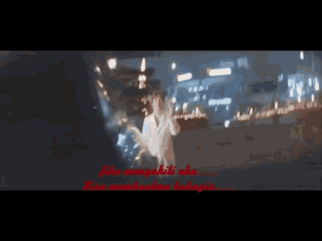 a blurry picture of a woman standing in front of a city at night