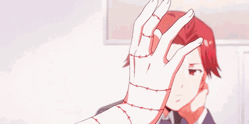 a girl with white hair and red eyes is holding her hand to her face .