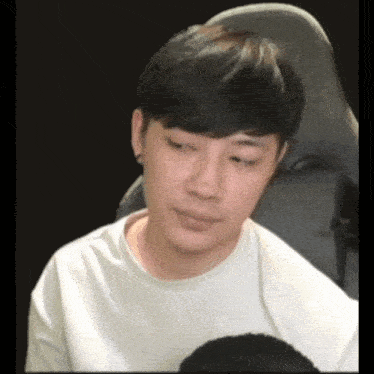 a man is sitting in a chair with his eyes closed