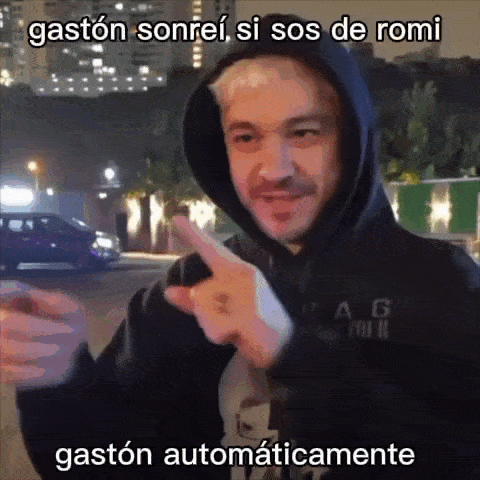a man in a hoodie is pointing at the camera with the words gaston sonrei si sos de romi written below him .