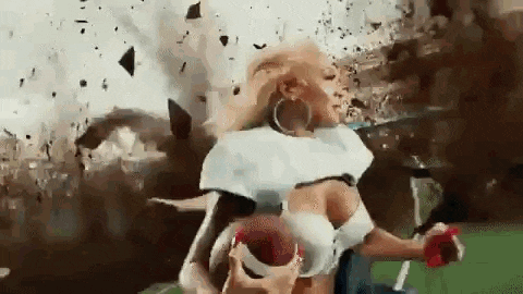 a woman in a football uniform is running on a field with a football in her hands .