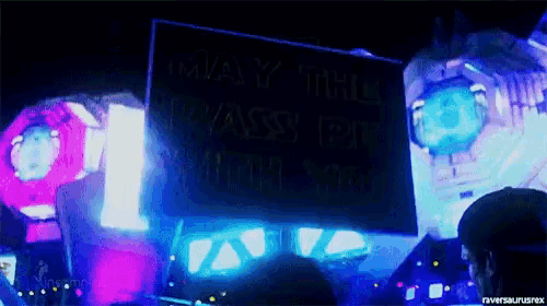 a sign that says may the pass be with you is lit up at night