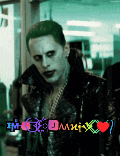 a man in a joker costume is standing in front of a sign that says i 'm a joker