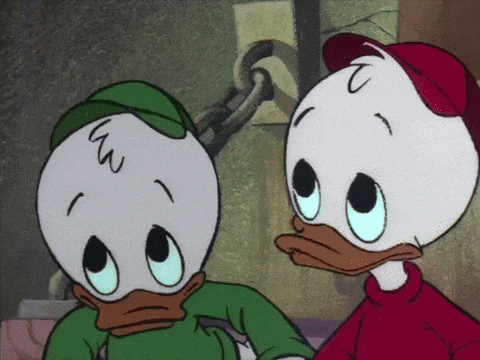 two cartoon ducks are standing next to each other and one has the letter w on its forehead