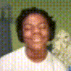 a blurry picture of a man wearing headphones and smiling