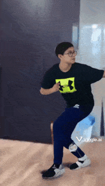 a person wearing a black under armour shirt and blue pants