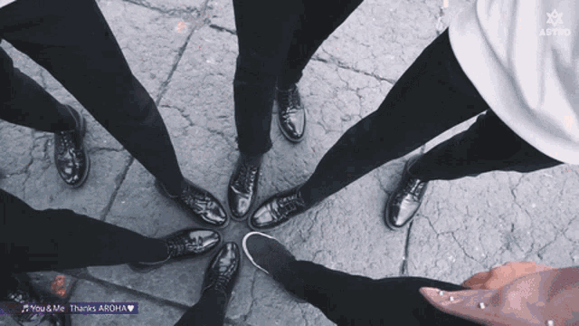 a group of people standing in a circle with the words you & me thanks aroha written on the bottom