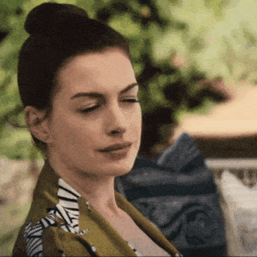 a woman with her eyes closed and a bun on her hair