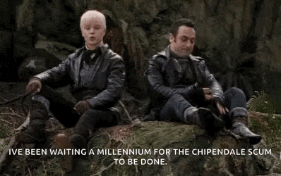 two men are sitting on a rock in the woods and waiting for the chipendale scum to be done .