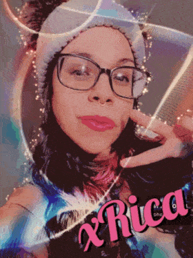 a woman wearing glasses and a headband with the name x rica on the bottom right