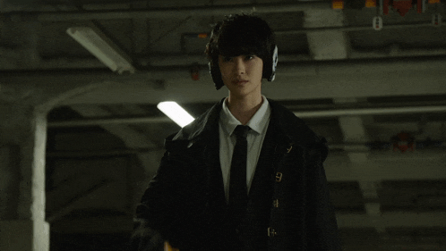 a man in a suit and tie is holding a gun with a sticker on it that says ' i '