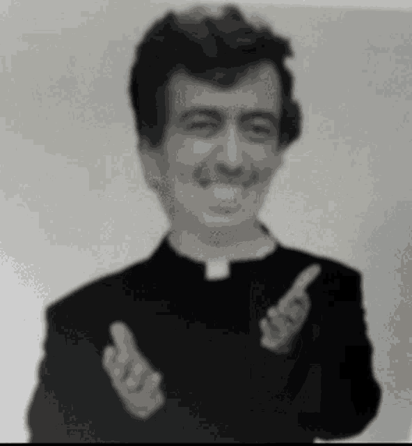a black and white photo of a priest giving the thumbs up