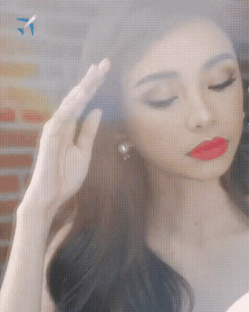 a woman with red lips is looking at herself in a mirror