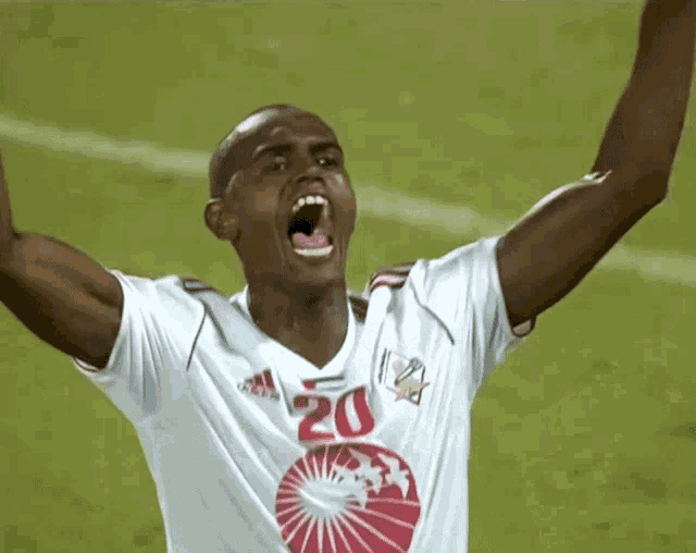 a soccer player wearing a white adidas jersey with the number 20 on it
