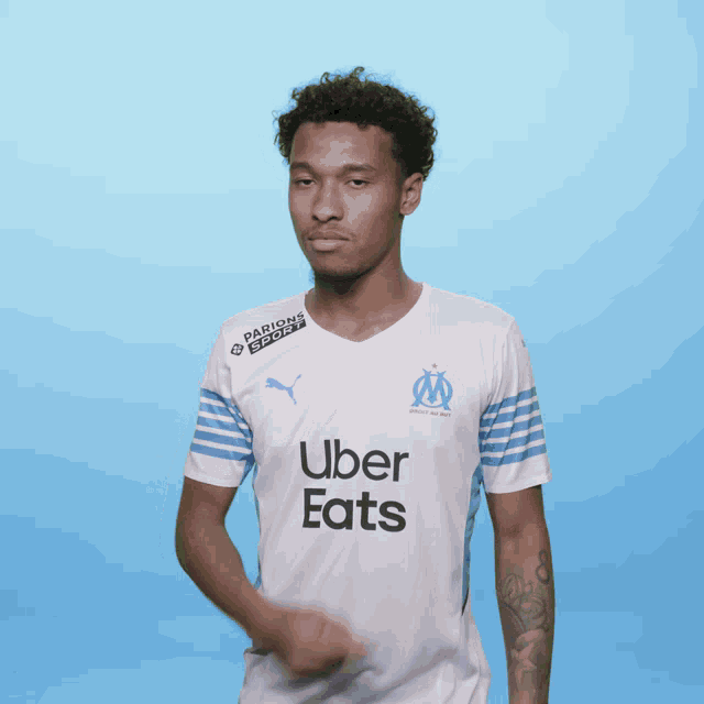 a man wearing a white uber eats jersey