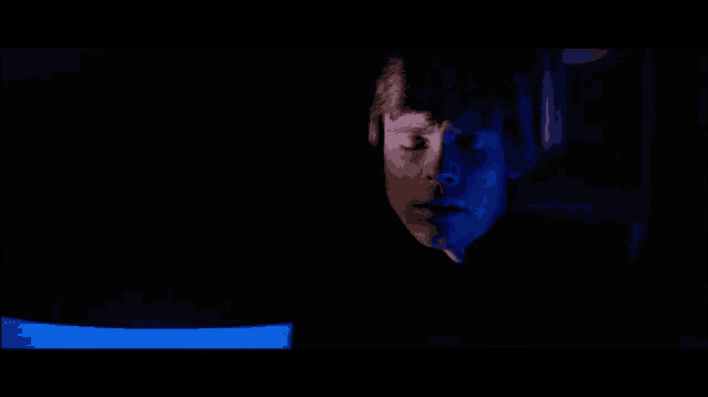 a close up of a man 's face in the dark
