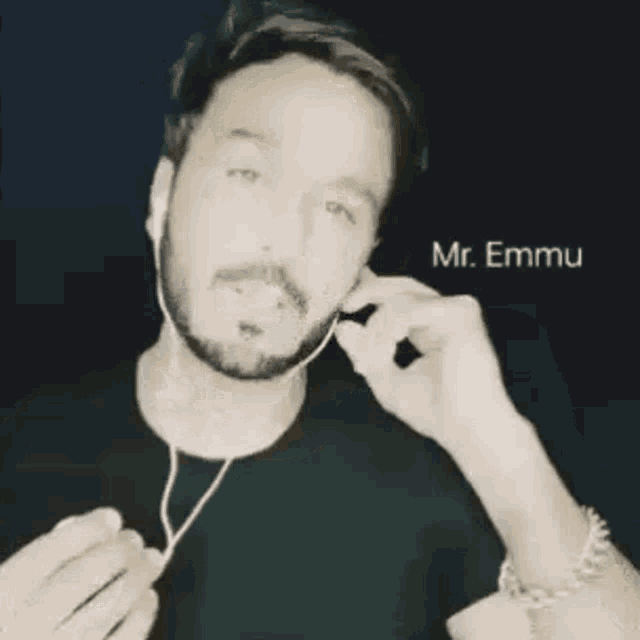 a man with a beard is wearing headphones and the name mr. emmu is on the bottom of the photo