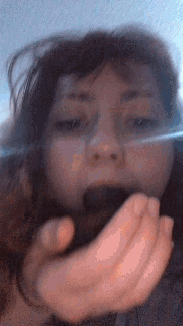 a close up of a woman 's face with a blue background