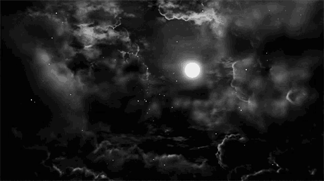 a black and white photo of a full moon in a cloudy sky