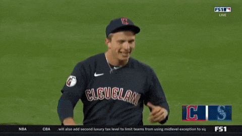 a baseball player for the cleveland guardians looks down at the scoreboard