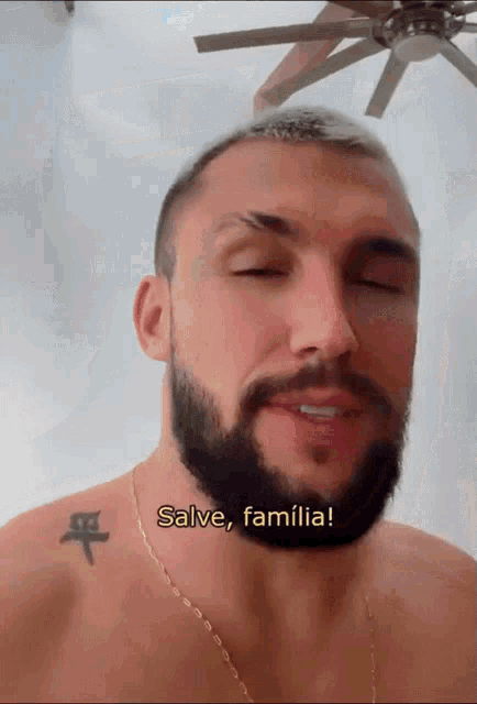 a man with a beard and a tattoo says salve familia