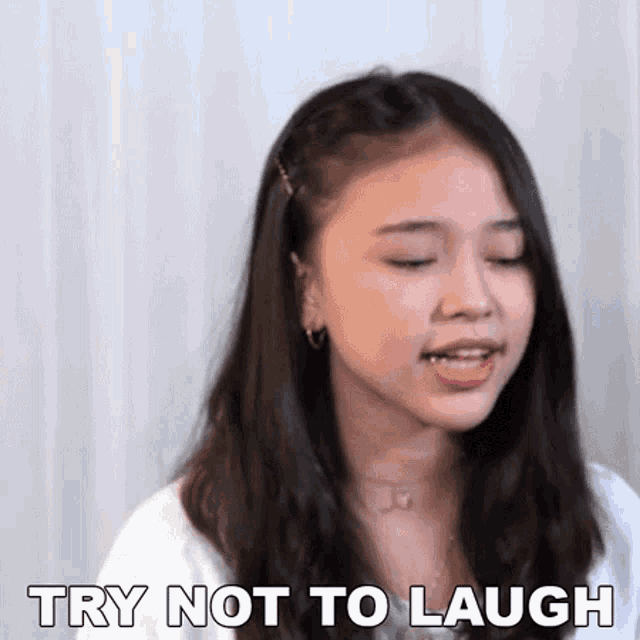 a young woman is making a funny face and says `` try not to laugh '' .