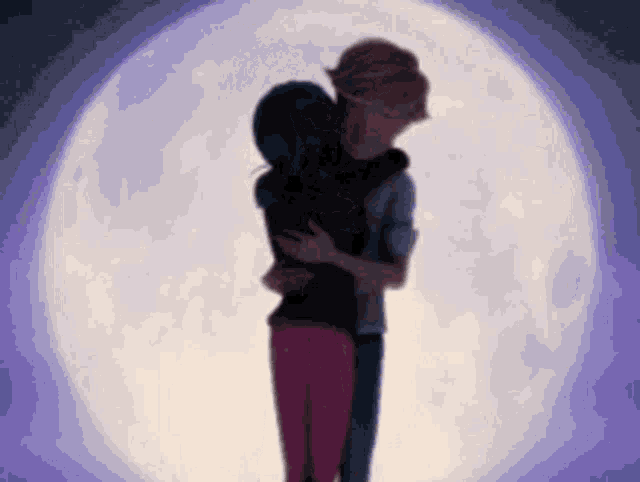 a man and woman hugging in front of a full moon .