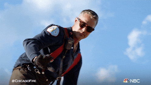 a man wearing sunglasses and a chicago fire uniform