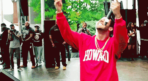 a man wearing a red sweater that says howao on it