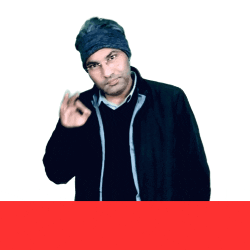 a man wearing a black jacket and a blue beanie is giving an ok sign