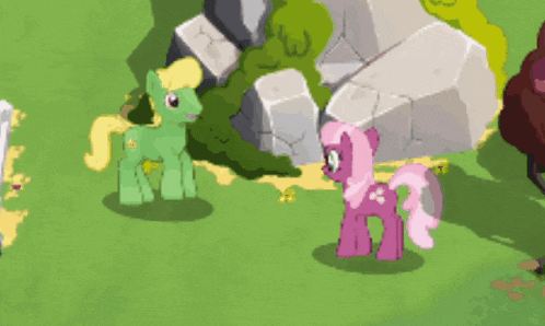 a green pony and a pink pony are standing in a field
