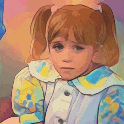a little girl with pigtails is wearing a blue and yellow shirt