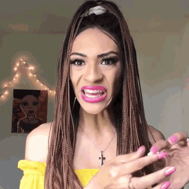 a woman with braces on her teeth is wearing a yellow top