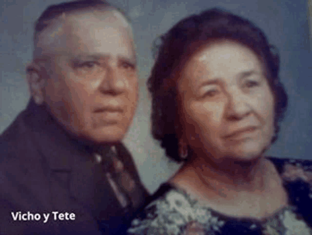 a man and a woman are posing for a picture with the name vicho y tete written below them