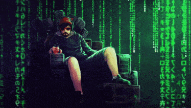 a man with a beard is sitting in front of a computer monitor