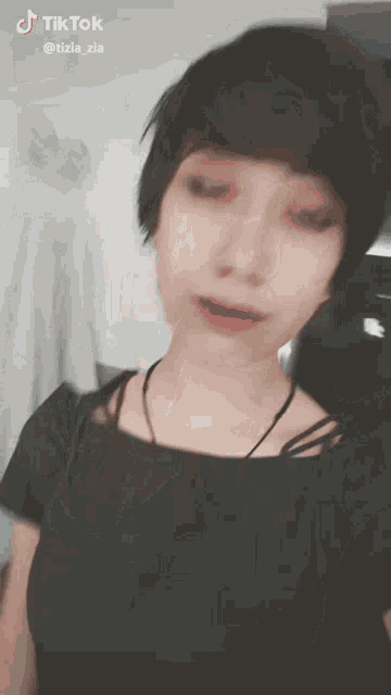 a girl with short hair is taking a selfie with tiktok written on the bottom