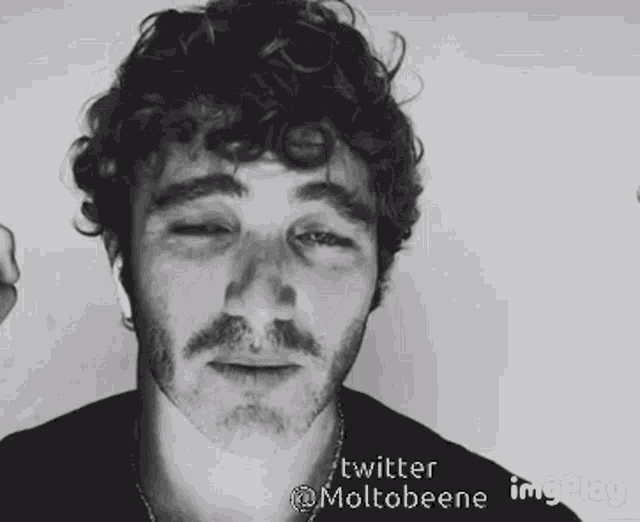 a man with curly hair and a beard has a twitter account