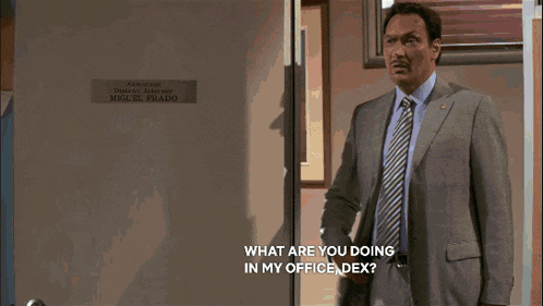 a close up of a man 's face with the words " what are you doing in my office dex " above him