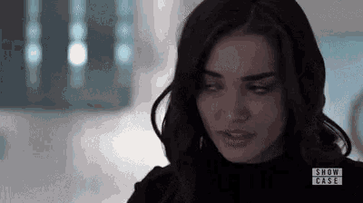 a close up of a woman 's face with a black shirt on .