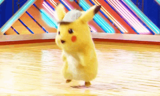 a pikachu is dancing on a wooden floor