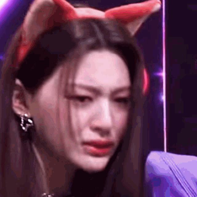 a close up of a woman wearing a cat ear headband .